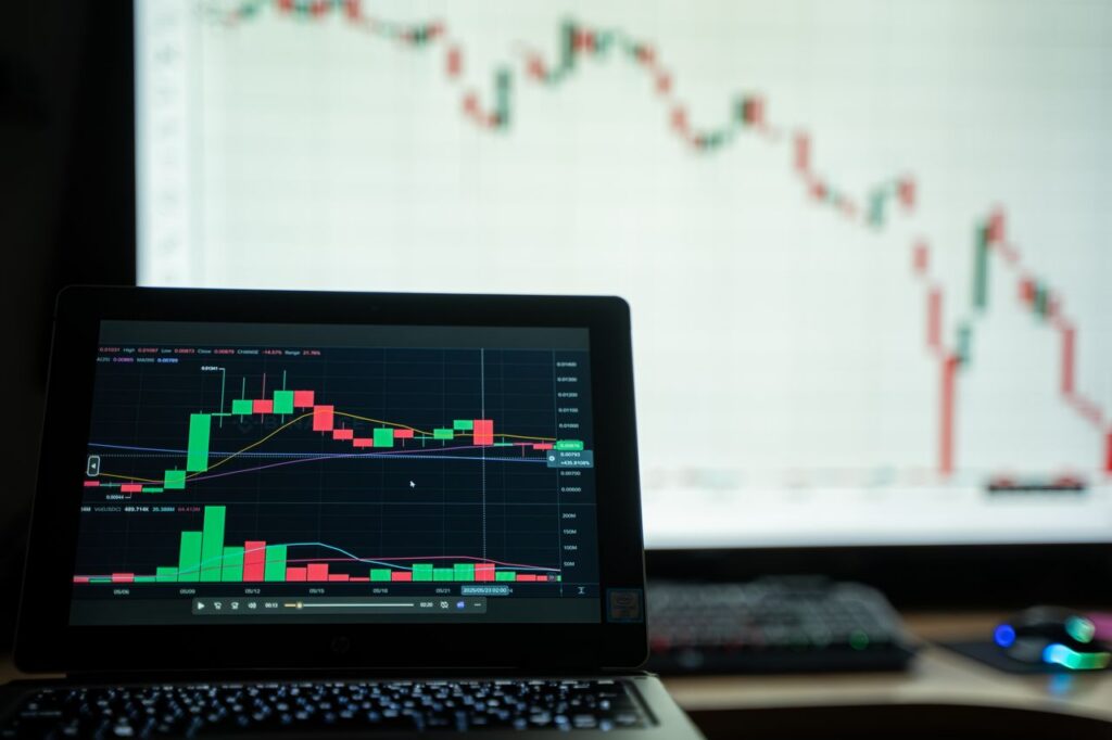 Close-up of a laptop showing cryptocurrency market charts in a trading environment.